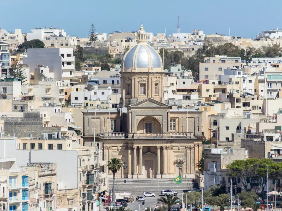 A domed church above a marina full of yachts