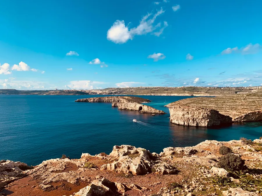 Rocky Maltese coast and open sea under a blue sky