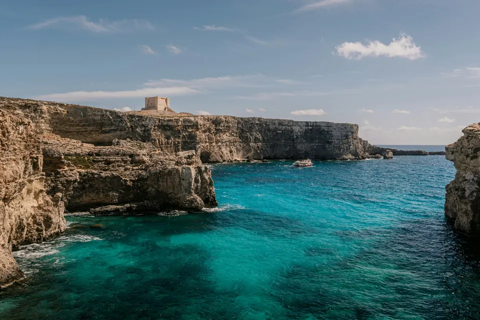 Limestone cliffs dropping to a green-blue sea