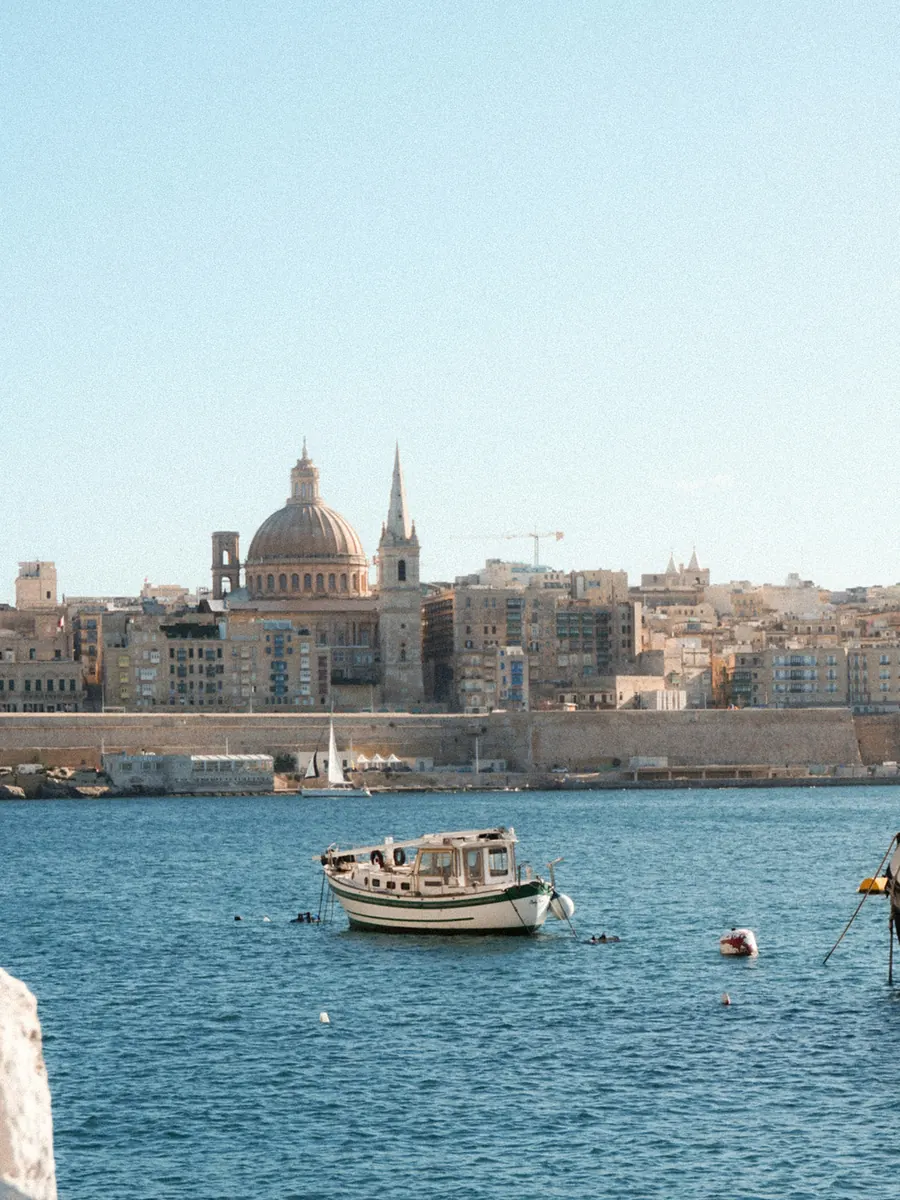 Valletta’s skyline seen across the harbour from a railing